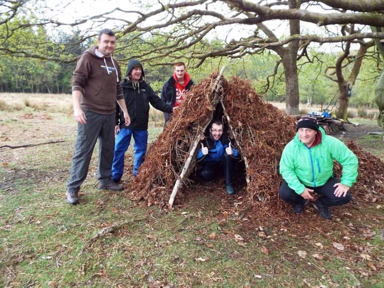 A group of people outsides making a tree canopy