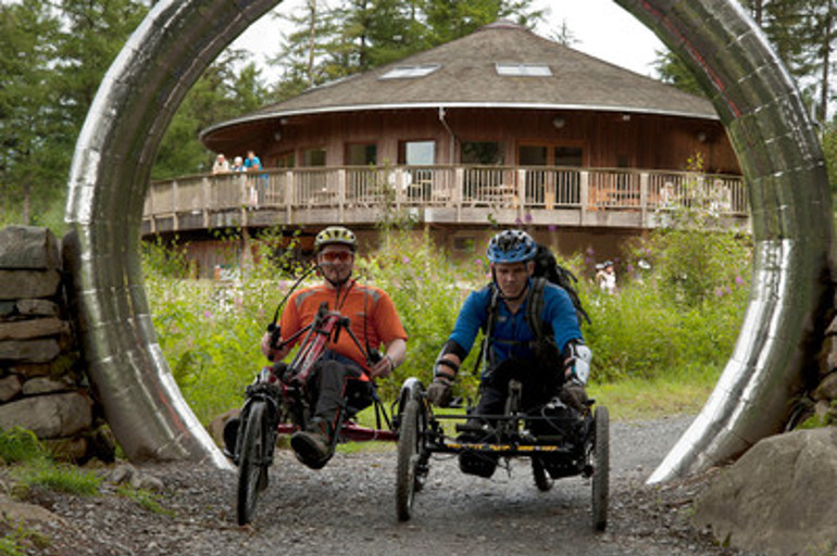 Two men riding tricycles