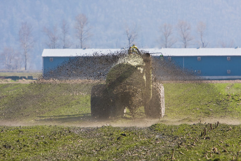 Tractor muck spreading on a farm