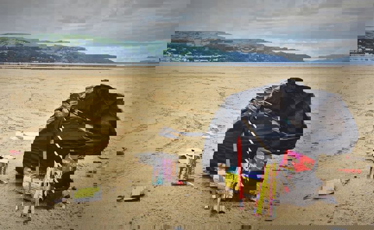 A black bag of fireworks on a beach