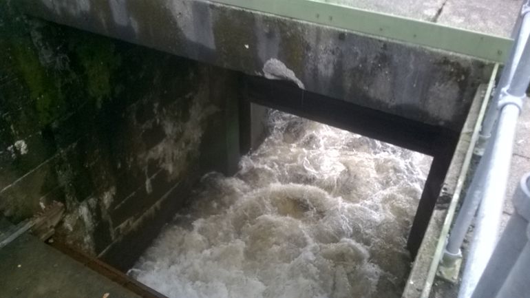 Sluce gate with water pouring into the river