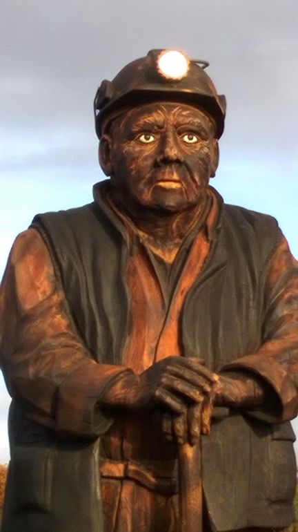 The Keeper of the Collieries is a nine foot tall, one and a half tonnes wooden statue at the Spirit of Llynfi Woodland site