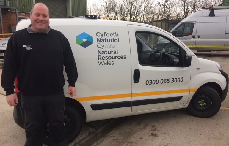 Allyn Hawkes next to his van