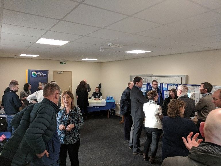 picture of our staff discuss the flooding with people in Llangefni
