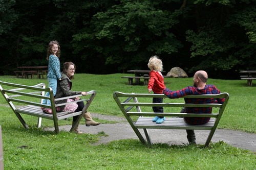 Family on park benches in Clywedog Valley