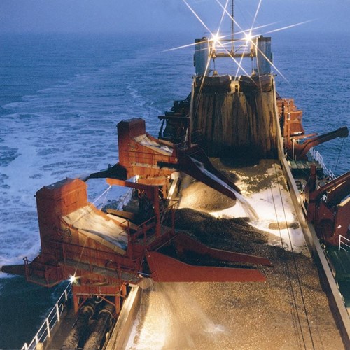A Purpose Built Marine Aggregate Dredging Ship Operating In Welsh Waters At Night.