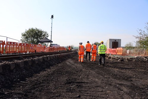 Four workers walking on site