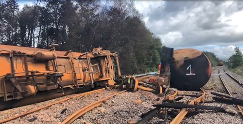 Derailed train laying on its side.